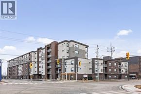 Tecumseh condo for rent - A large apartment complex with a REALTOR® logo on the top left corner.