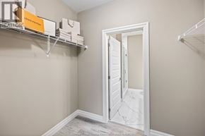 Tecumseh condo for rent - A white door is open to a hallway with a shelf above it.