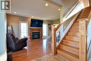 Essex other for rent - A living room with a brown couch and a fireplace.