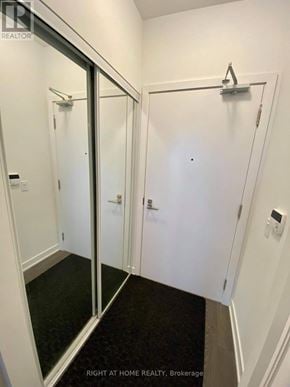 Mississauga (Central Erin Mills) condo for rent - A white bathroom with a glass door and a towel rack.