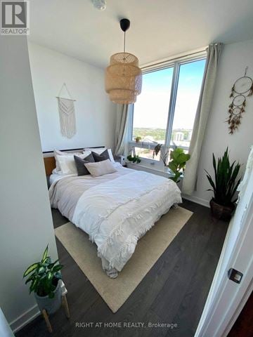 Mississauga (Central Erin Mills) condo for rent - A bedroom with a large bed and a view of the city.