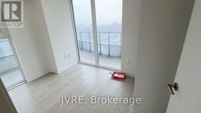 Brampton (Fletcher's Creek South) condo for rent - A room with a view of the city through large windows.