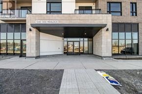 Ottawa condo for rent - The entrance to a building with a sign that reads "1340-1350 HEMLOCK".