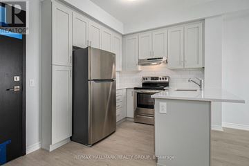 Ottawa condo for rent - A kitchen with a stainless steel refrigerator and a stove top oven.