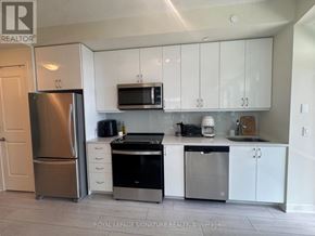 Toronto (Mimico) condo for rent - A kitchen with white cabinets and stainless steel appliances.