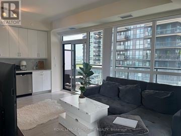 Toronto (Mimico) condo for rent - A modern living room with a grey couch and a white coffee table.