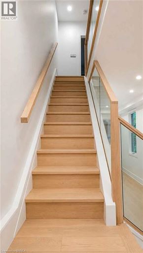 Hamilton apartment for rent - A wooden staircase with glass balustrade.