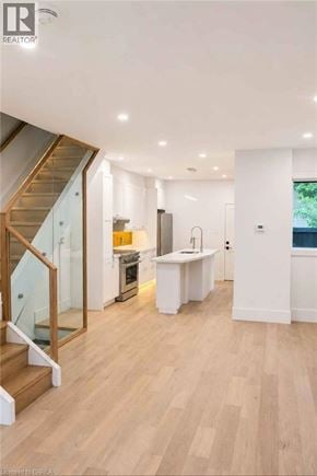 Hamilton apartment for rent - A modern kitchen with a wooden floor and white walls.