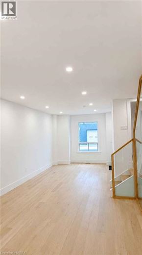Hamilton apartment for rent - A spacious room with wooden flooring and a window.