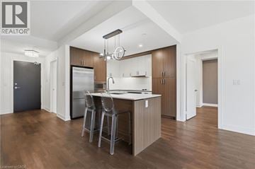 Mississauga condo for rent - A modern kitchen with wooden cabinets and a central island.