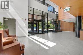 Mississauga condo for rent - A modern office lobby with a glass door and a brown leather chair.