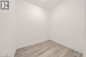 Waterdown condo for rent - A room with wooden flooring and white walls.