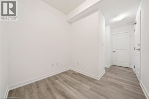 Waterdown condo for rent - A room with wooden flooring and white walls.