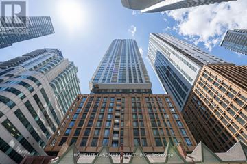 Toronto (Waterfront Communities) condo for rent - A view of a cityscape with tall buildings and a clear blue sky.