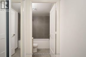 Toronto (Waterfront Communities) condo for rent - A white bathroom with a toilet and a shower stall.