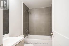 Toronto (Waterfront Communities) condo for rent - A bathroom with a tub and a shower.