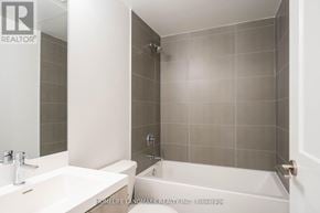 Toronto (Waterfront Communities) condo for rent - A bathroom with a white sink and a white bathtub.