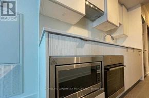 Toronto (Mount Pleasant West) condo for rent - A modern kitchen with a stainless steel oven and white cabinets.