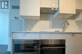 Toronto (Mount Pleasant West) condo for rent - A modern kitchen with a stainless steel oven and white cabinets.