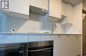 Toronto (Mount Pleasant West) condo for rent - A modern kitchen with white cabinets and a stainless steel oven.
