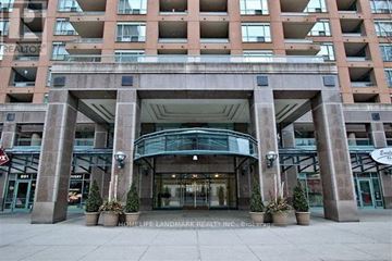 Toronto (Bay Street Corridor) condo for rent - The entrance to a building with a sign that reads "HomeLife Landmark Realty, Inc."