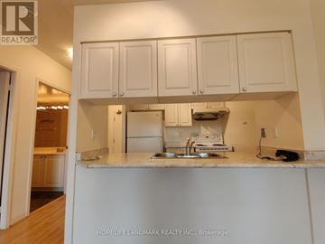 Toronto (Bay Street Corridor) condo for rent - A kitchen with white cabinets and a marble countertop.
