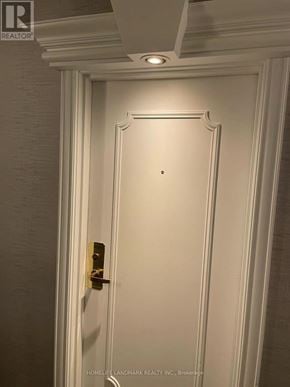 Toronto (Bay Street Corridor) condo for rent - A white door with a gold handle and a sign above it that says "HOMELAND LANDMARK REALTY INC., Brokerage".