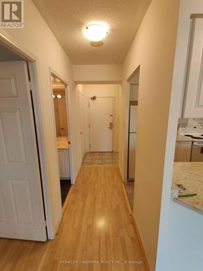 Toronto (Bay Street Corridor) condo for rent - A hallway with a white door and a white wall.