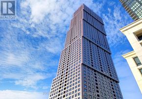Vaughan (Concord) condo for rent - A tall building with a blue sky in the background.