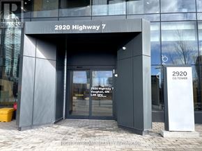 Vaughan (Concord) condo for rent - The entrance to the 2920 Highway 7 CG Tower with a sign that reads "2920 Highway 7" and "Vaughan 2014".
