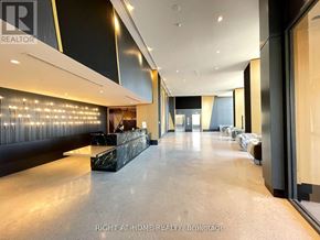 Vaughan (Concord) condo for rent - A spacious hallway with a reception desk and chairs.