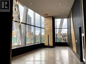 Vaughan (Concord) condo for rent - A spacious room with a view of the city through large windows.