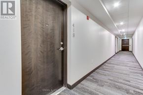 Barrie (Holly) condo for rent - A hallway with a door on the left and another door at the end of the hall.