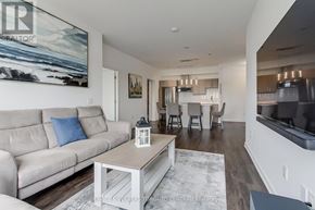 Barrie (Holly) condo for rent - A living room with a beige couch and a coffee table.