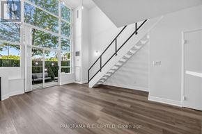 Toronto (Mimico) condo for rent - A spacious room with a staircase leading to the upper floor.