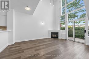 Toronto (Mimico) condo for rent - A spacious living room with wood flooring and a fireplace.