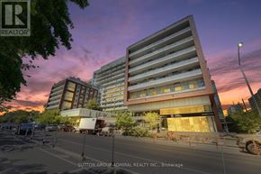Toronto (High Park North) condo for rent - A large building with a sign that says "REALTOR" on it.