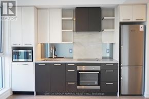 Toronto (High Park North) condo for rent - A kitchen with white cabinets and a black counter top.