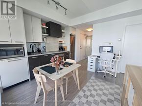 Toronto (High Park North) condo for rent - A modern kitchen with a dining table and chairs.