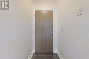 Mississauga (City Centre) condo for rent - A wooden door with a handle and a small square on the wall.