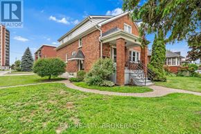 Kingston (Central City East) triplex for rent - A red brick house with a tree in front of it.