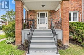 Kingston (Central City East) triplex for rent - A house with a white door and a brick wall.