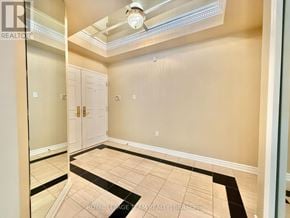 Ottawa condo for rent - A room with a ceiling fan and a door.