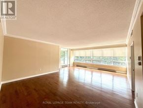 Ottawa condo for rent - A spacious room with wooden floors and a large window.