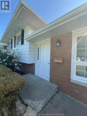 Kingsville apartment for rent - A house with a white door and a brick wall.