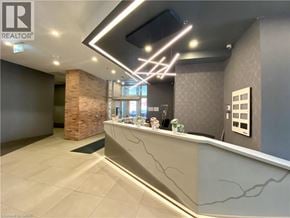 Kitchener condo for rent - A reception area with a stone pillar and a counter.
