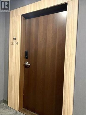 Kitchener condo for rent - A brown door with a handle and a number 3114 on it.