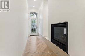 Toronto (Annex) townhouse for rent - A hallway with a wood floor and a glass door leading to a balcony.