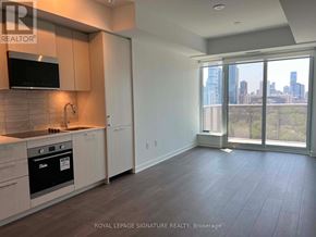 Toronto (Regent Park) condo for rent - A kitchen with a microwave, oven, and cabinets.