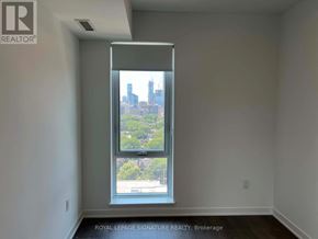 Toronto (Regent Park) condo for rent - A room with a large window showing a cityscape outside.